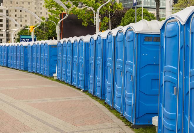 a row of portable restrooms ready for eventgoers in Coweta